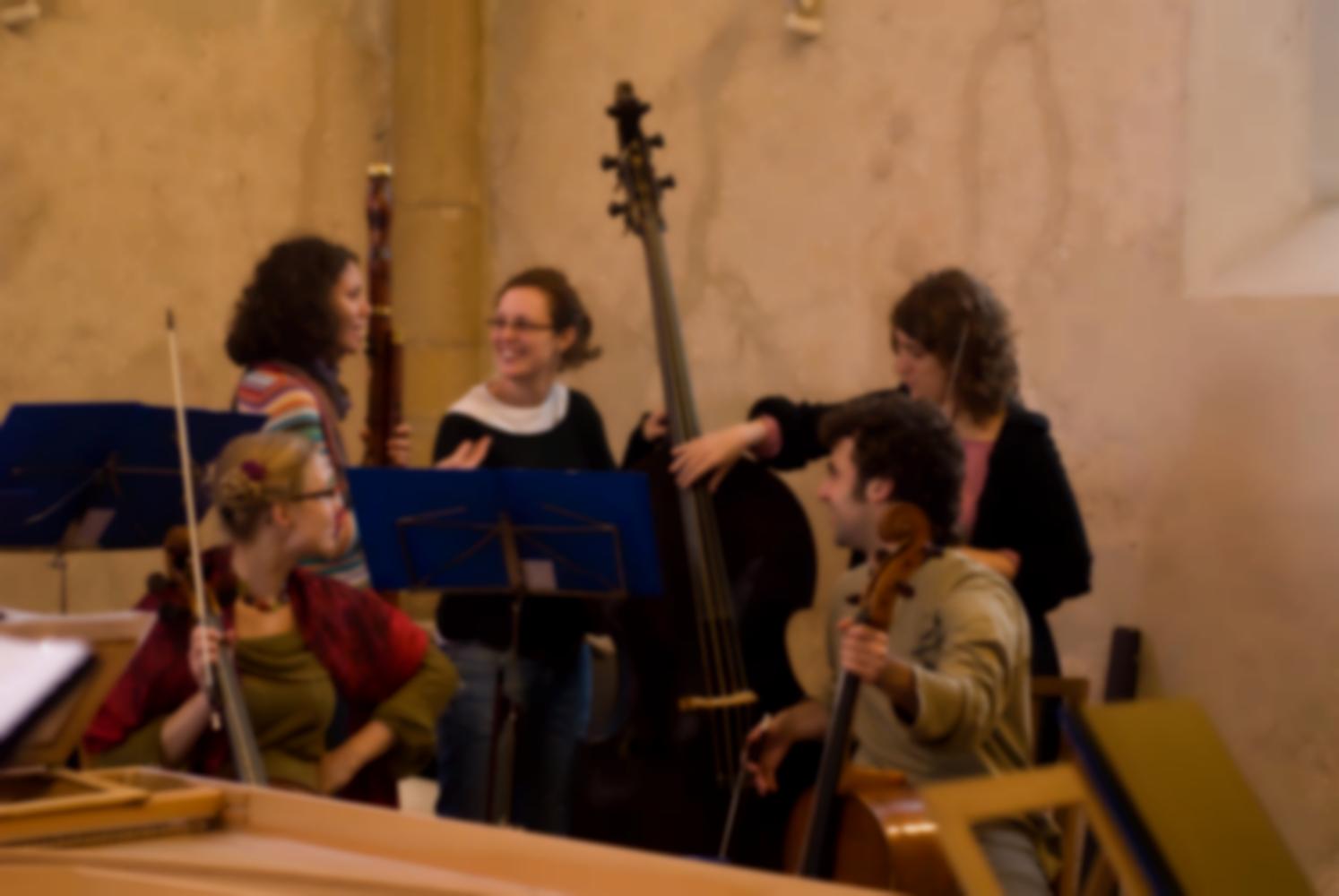 Dans l'église, les deux violoncellistes, la contrebassiste et la bassoniste plaisantent ensemble, une violoniste pince les cordes de la contrebasse. Echternach, Luxembourg, octobre 2009.