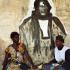 Ousmane pose avec un autre Baye Fall devant un mur décoré d'un grand portrait d'Ibrahima Fall. Touba, Sénégal, février 2008.