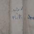 Quelques mots illisibles écrits au pastel bleu sur une porte du Faubourg Saint-Denis. Paris, février 2009.